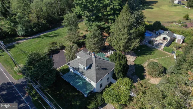 an aerial view of house with yard swimming pool and outdoor seating