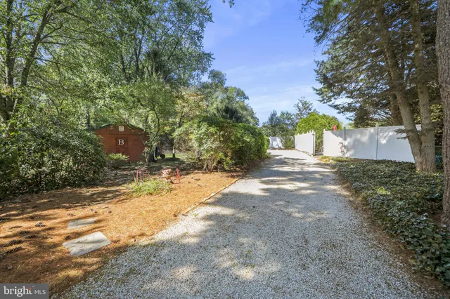 an aerial view of a house with a yard lake and outdoor seating