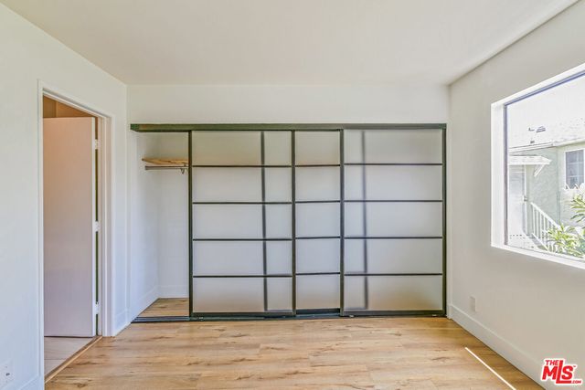 a view of a livingroom with wooden floor and a window