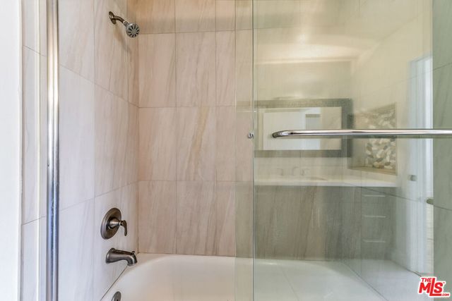a bathroom with a glass shower door