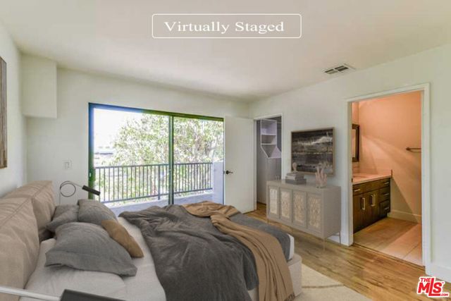 a bed room with a bed and a large window