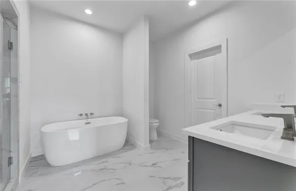 a spacious bathroom with a sink and a bathtub