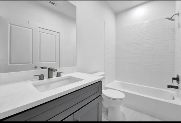 a bathroom with a sink a toilet and a bathtub