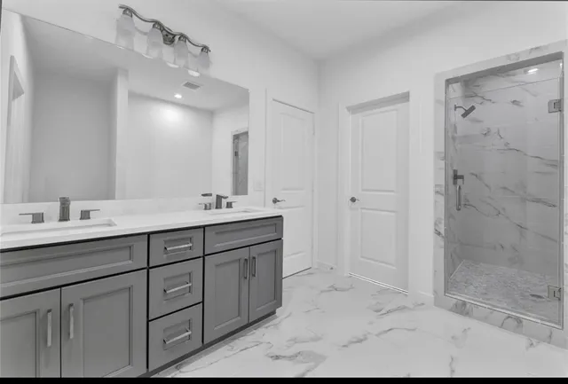 a bathroom with double sink and a mirror
