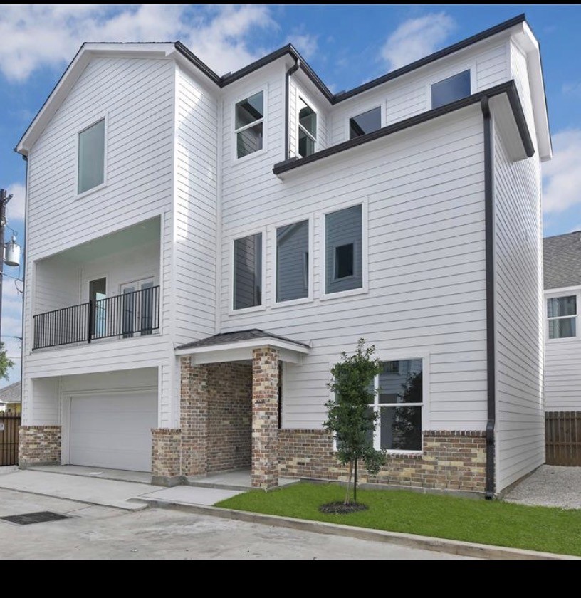 207 Edgewood Street, Unit B Houston, TX 77011 - Photo 18 of 23 a front view of a house with a garden and plants