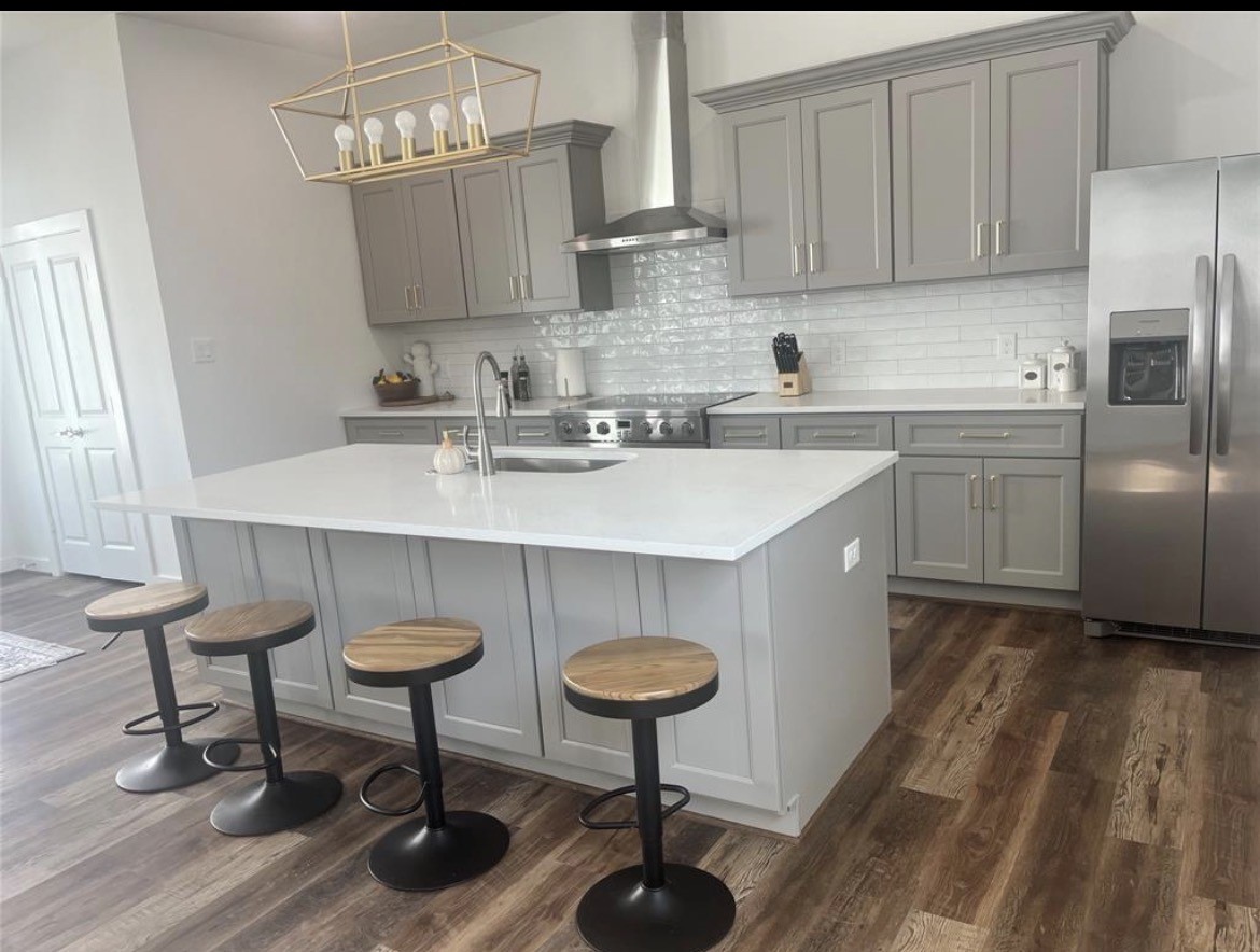 207 Edgewood Street, Unit B Houston, TX 77011 - Photo 22 of 23 a kitchen with stainless steel appliances a sink cabinets and wooden floor