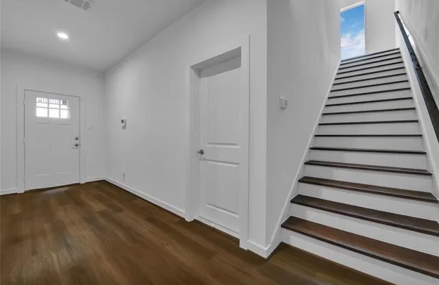 wooden floor in an empty room with stairs