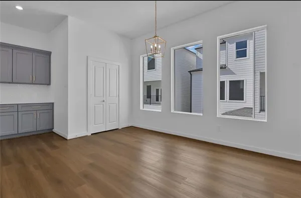 a view of empty room with wooden floor and cabinet