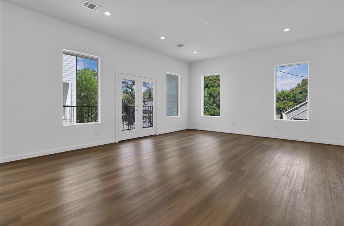 207 Edgewood Street, Unit B Houston, TX 77011 - Photo 8 of 23 a view of an empty room with wooden floor and a window