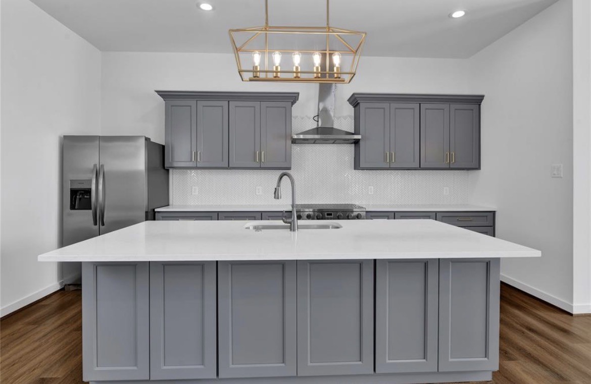 207 Edgewood Street, Unit B Houston, TX 77011 - Photo 10 of 23 a kitchen with a sink refrigerator and cabinets
