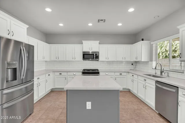 a view of a kitchen with furniture and a ceiling fan