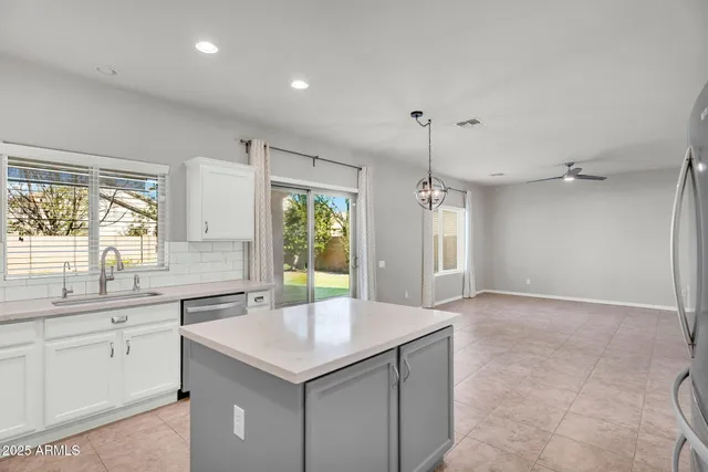 a kitchen with white cabinets appliances and sink