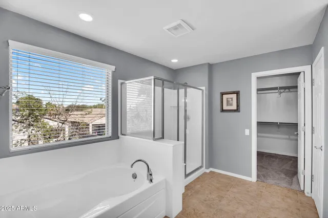 a bathroom with double vanity sinks and a mirror
