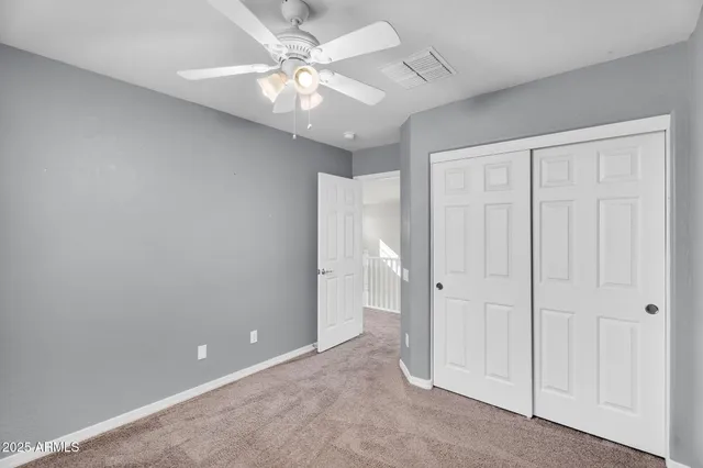 an empty room with a ceiling fan