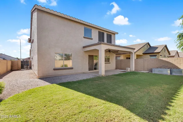 a front view of a house with a garden and yard