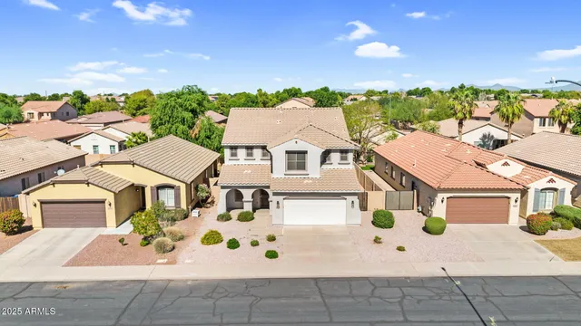 a view of residential houses with flower plants and wooden fence