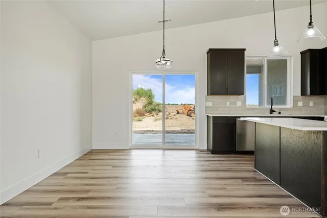 a view of a kitchen with a sink and wooden floor