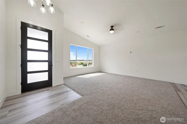 an empty room with windows and cabinet