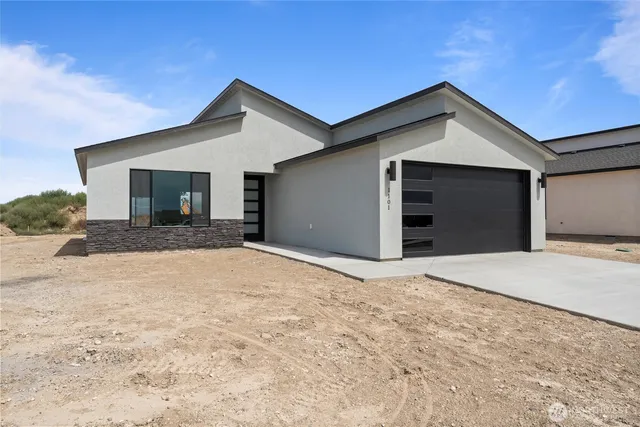 a view of a house with a yard and garage