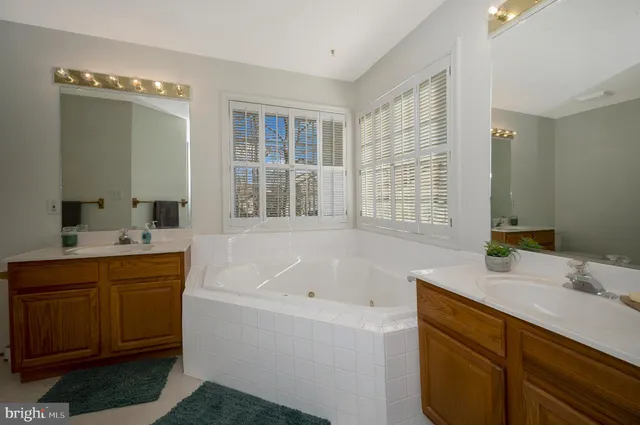 a front view of a house with a yard and potted plants