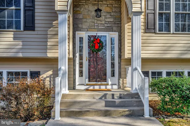 a view of a house with wooden stairs and wooden fence