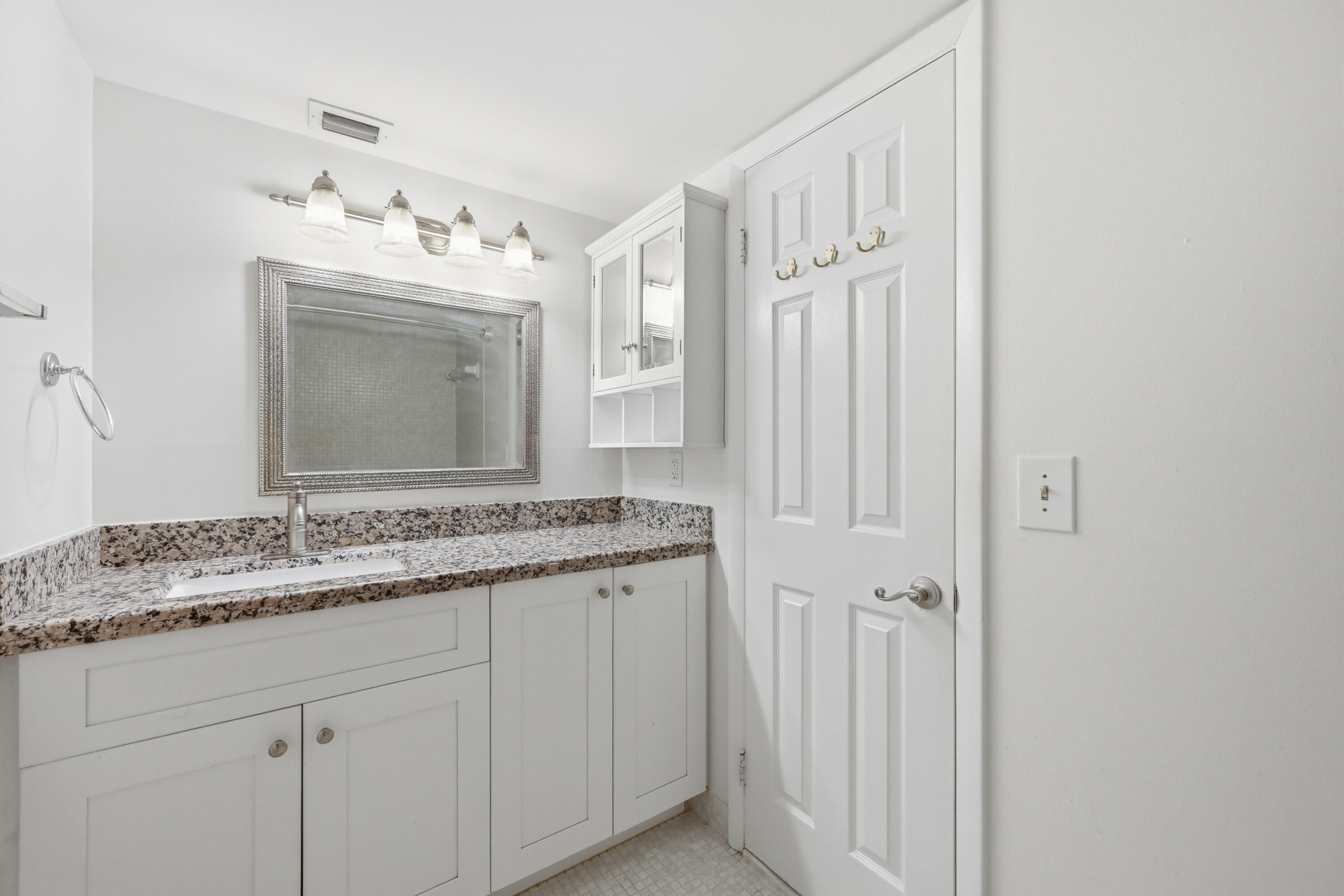5700 Northwest 2nd Avenue, Unit 604 Boca Raton, FL 33487 - Photo 14 of 43 a bathroom with a granite countertop sink vanity mirror and bathtub