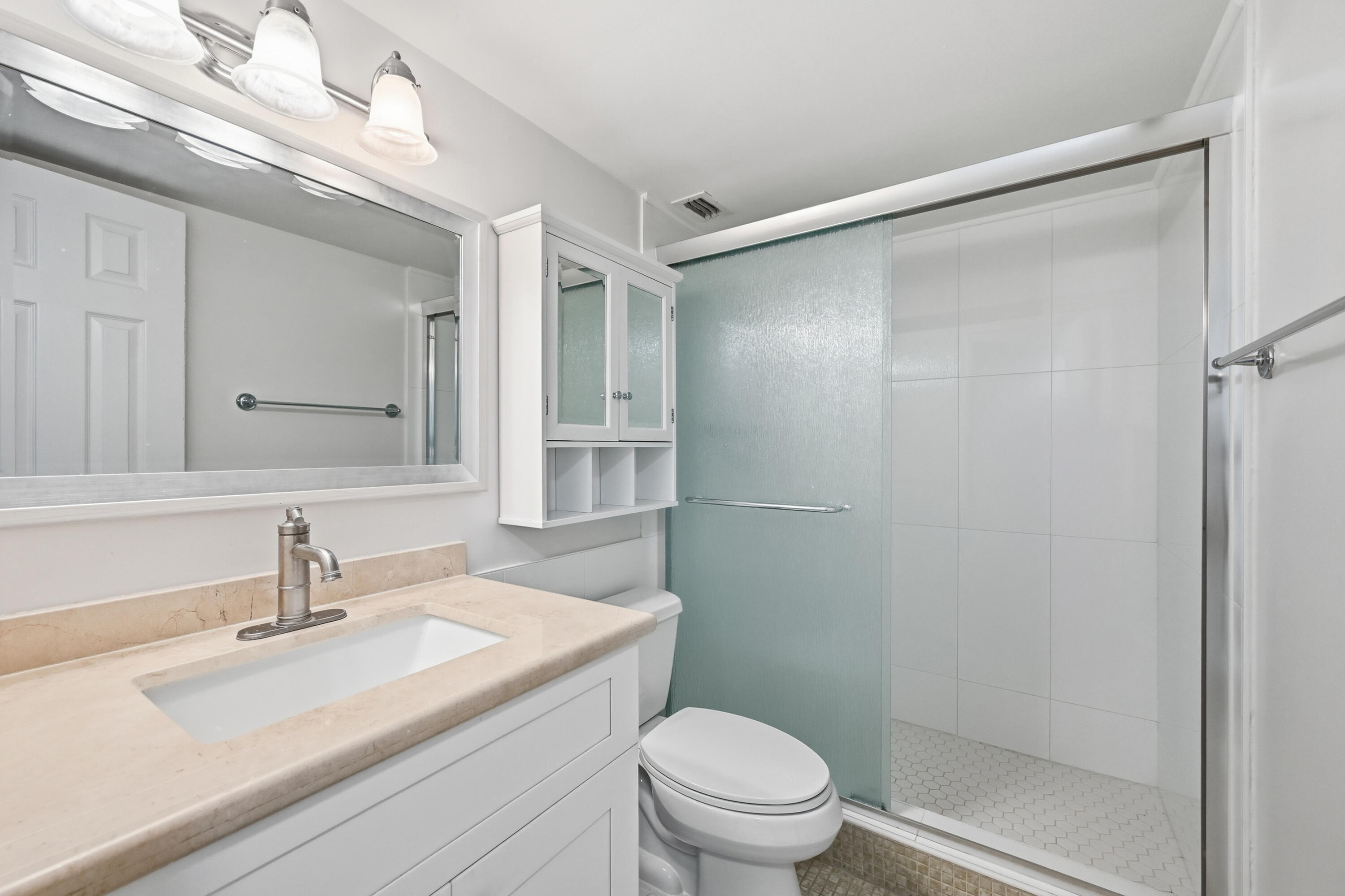 5700 Northwest 2nd Avenue, Unit 604 Boca Raton, FL 33487 - Photo 16 of 43 a bathroom with a sink a mirror and a toilet