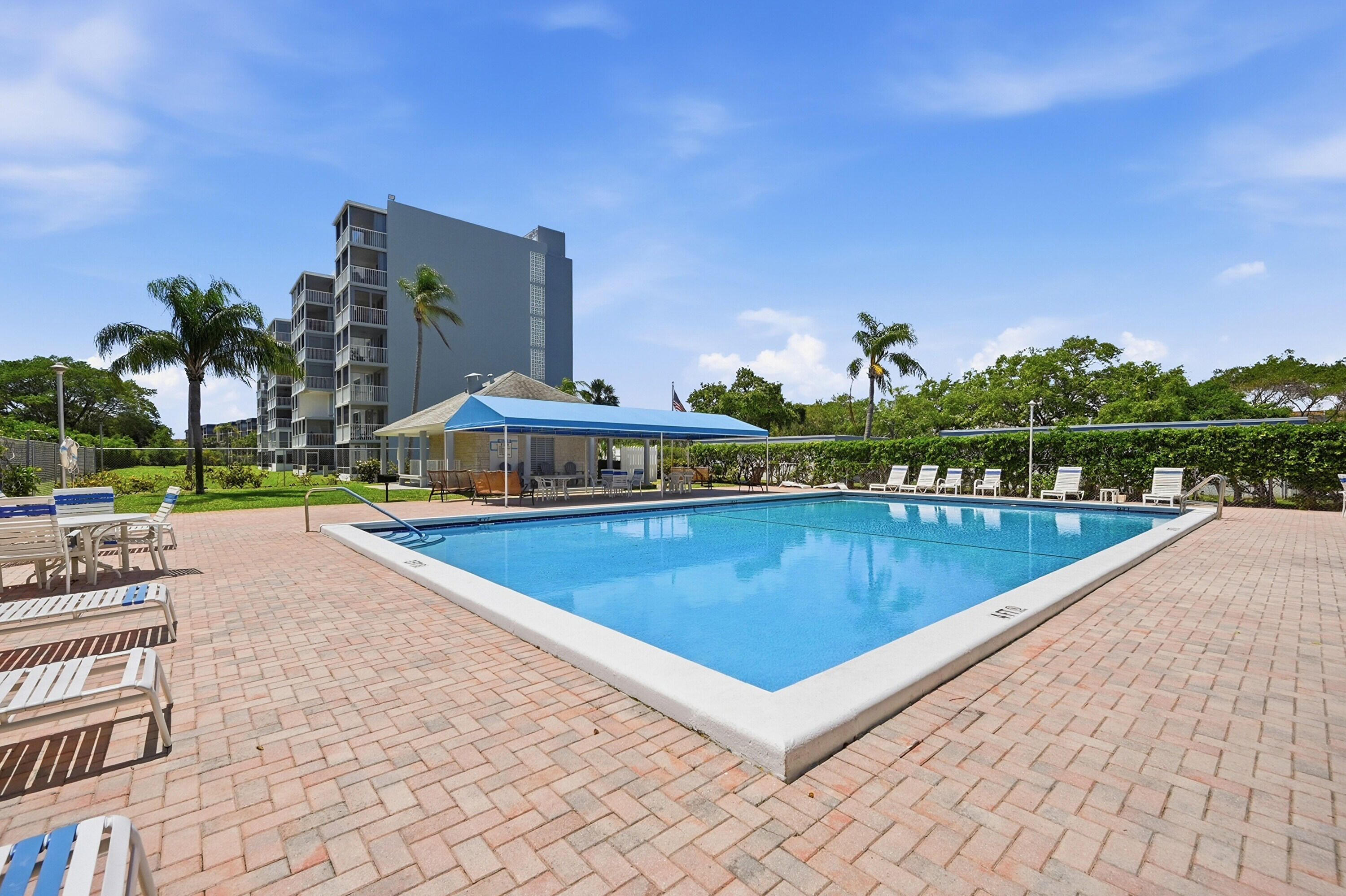 5700 Northwest 2nd Avenue, Unit 604 Boca Raton, FL 33487 - Photo 2 of 43 a view of a swimming pool with an outdoor seating and a garden