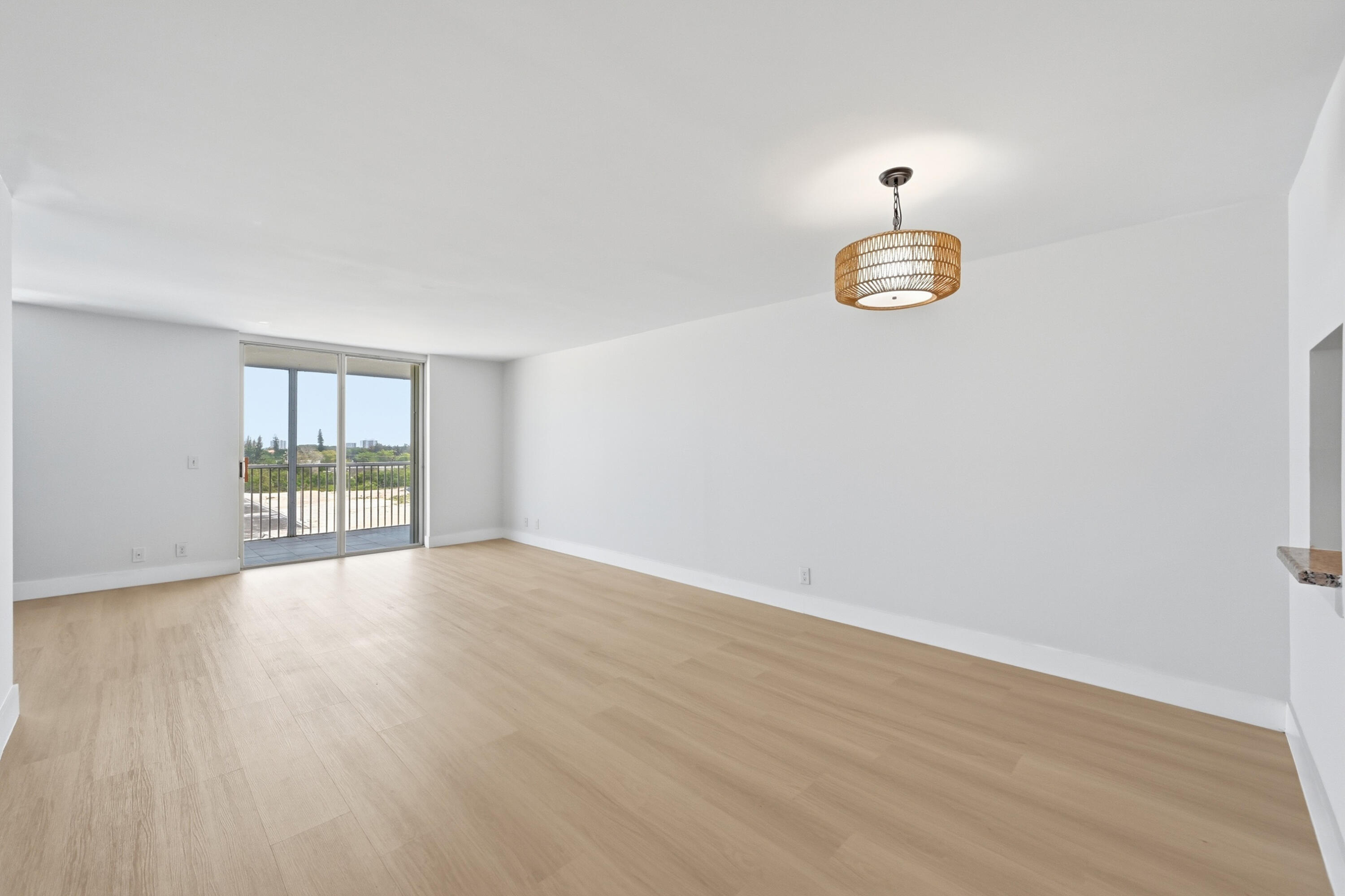 5700 Northwest 2nd Avenue, Unit 604 Boca Raton, FL 33487 - Photo 4 of 43 an empty room with wooden floor and window