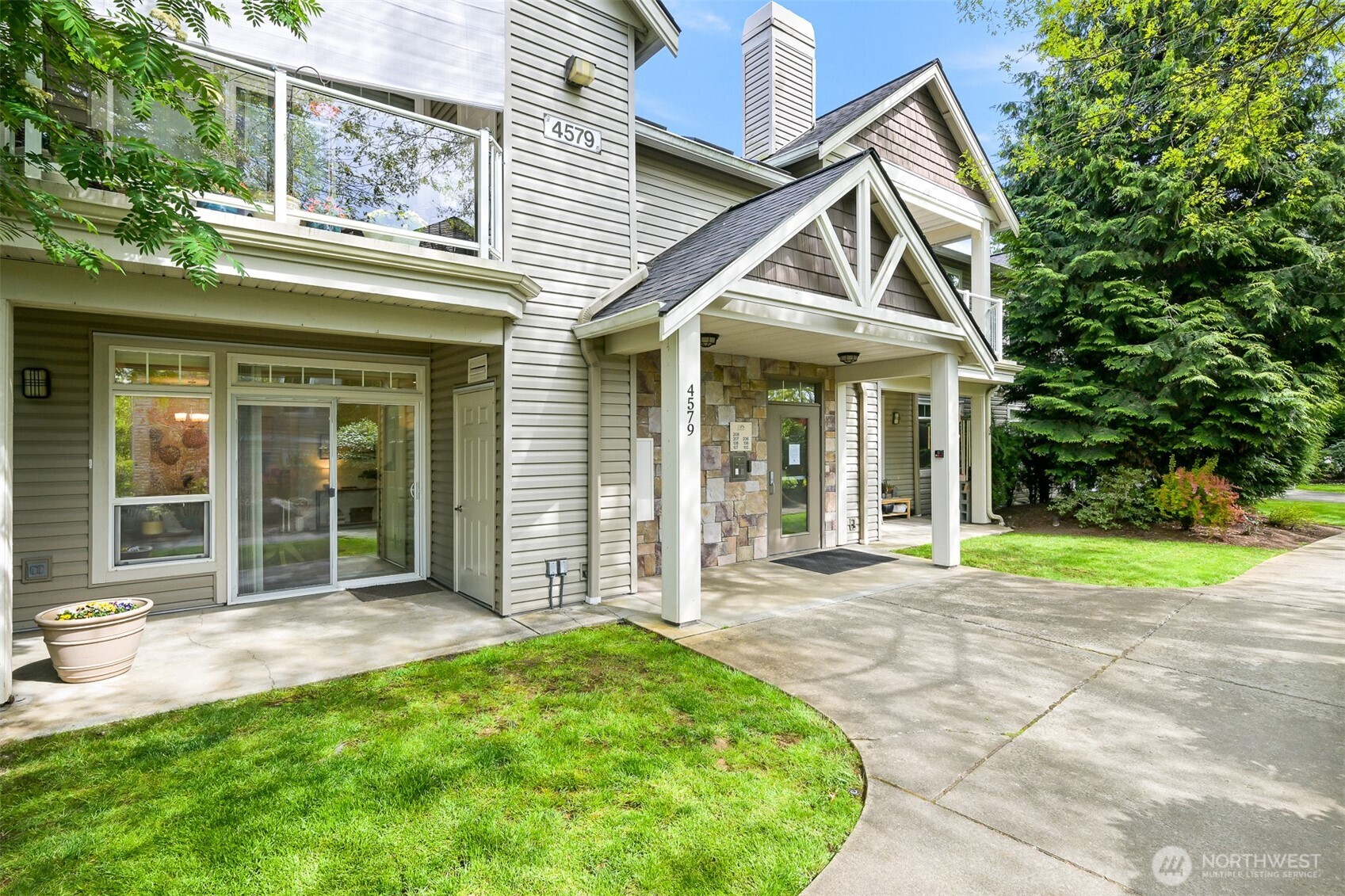 a view of a house with a yard and sitting area