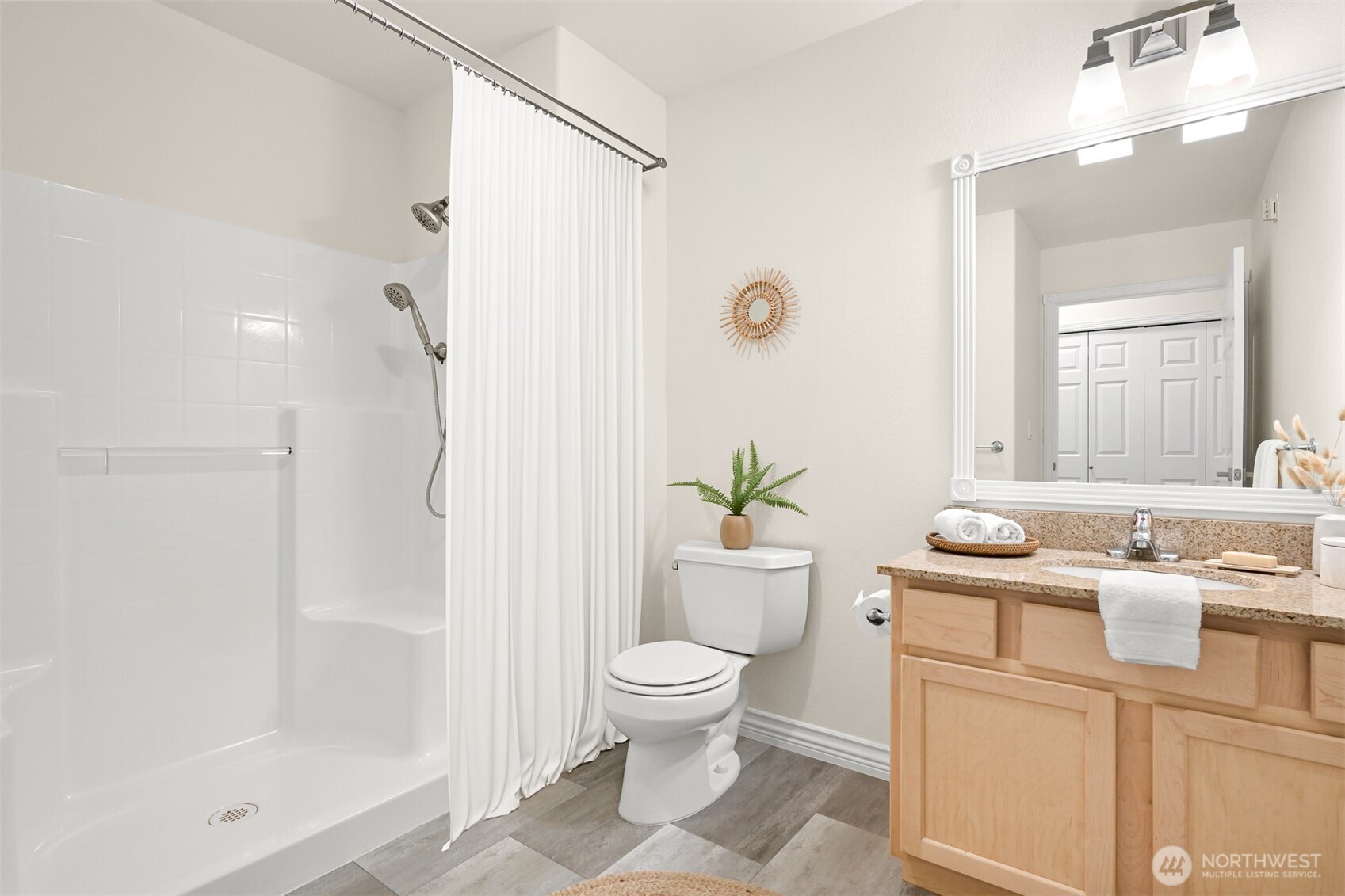 4579 El Dorado Way, Unit 107 Bellingham, WA 98226 - Photo 23 of 40 a bathroom with a granite countertop sink a toilet and shower
