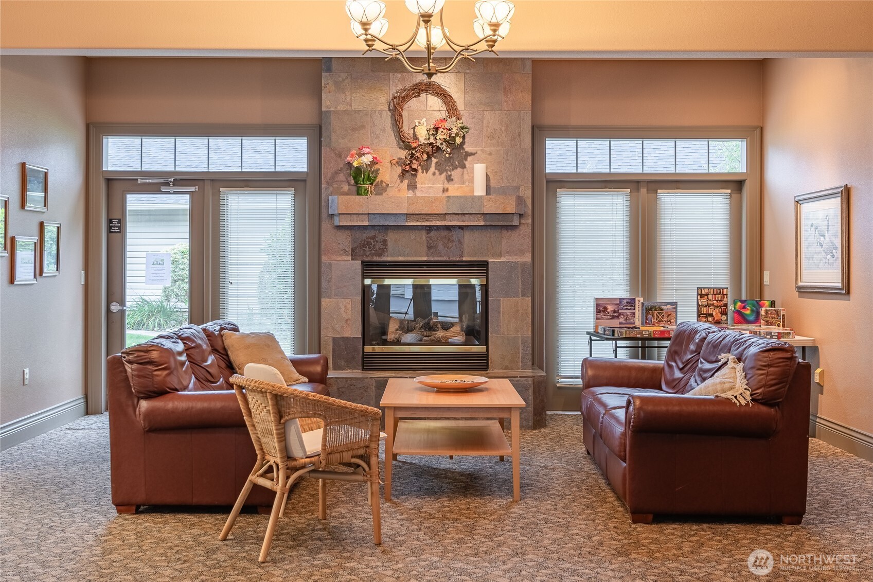 4579 El Dorado Way, Unit 107 Bellingham, WA 98226 - Photo 29 of 40 a living room with furniture a fireplace and a chandelier