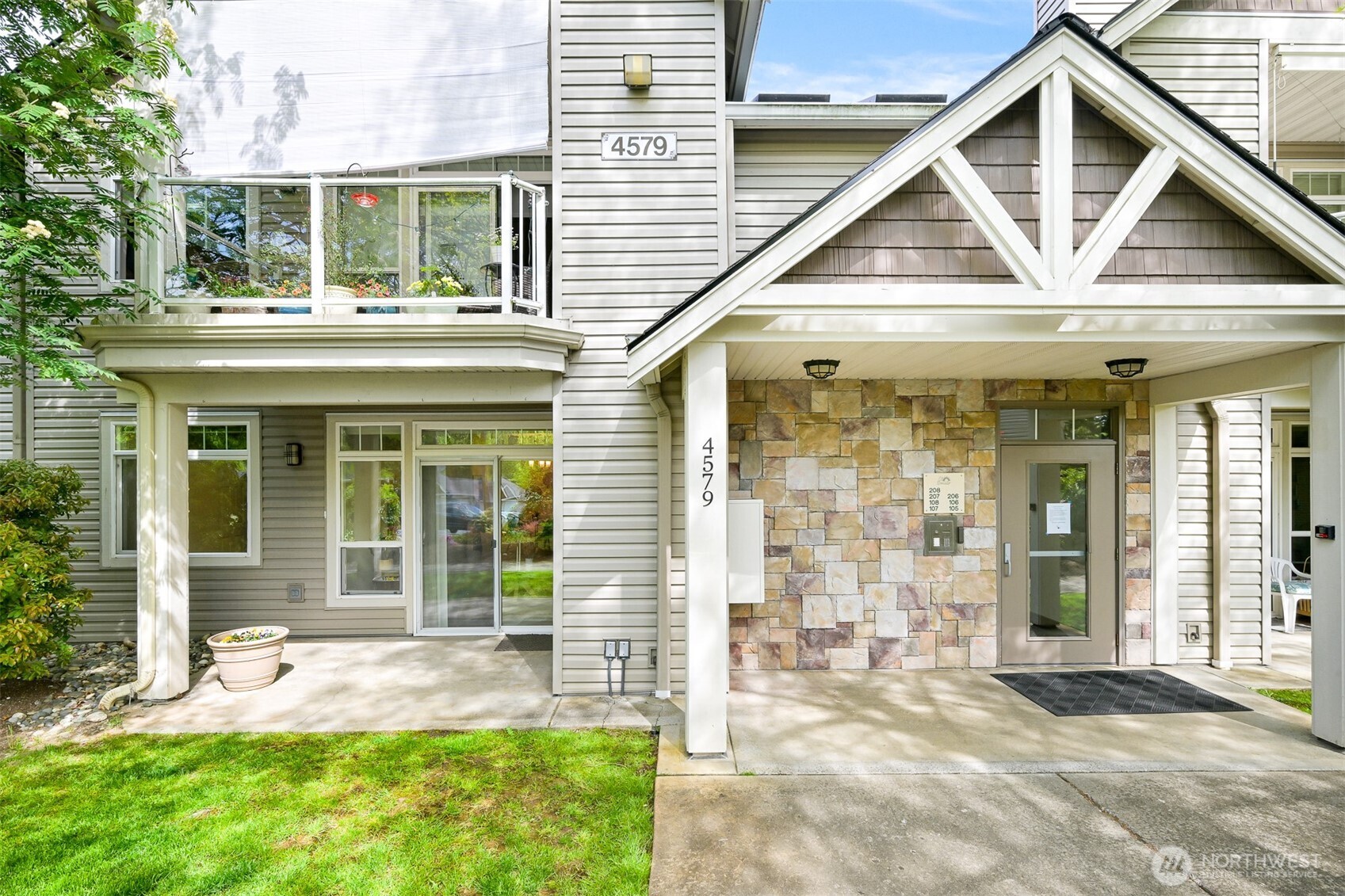4579 El Dorado Way, Unit 107 Bellingham, WA 98226 - Photo 34 of 40 a view of a brick house with large windows and a yard