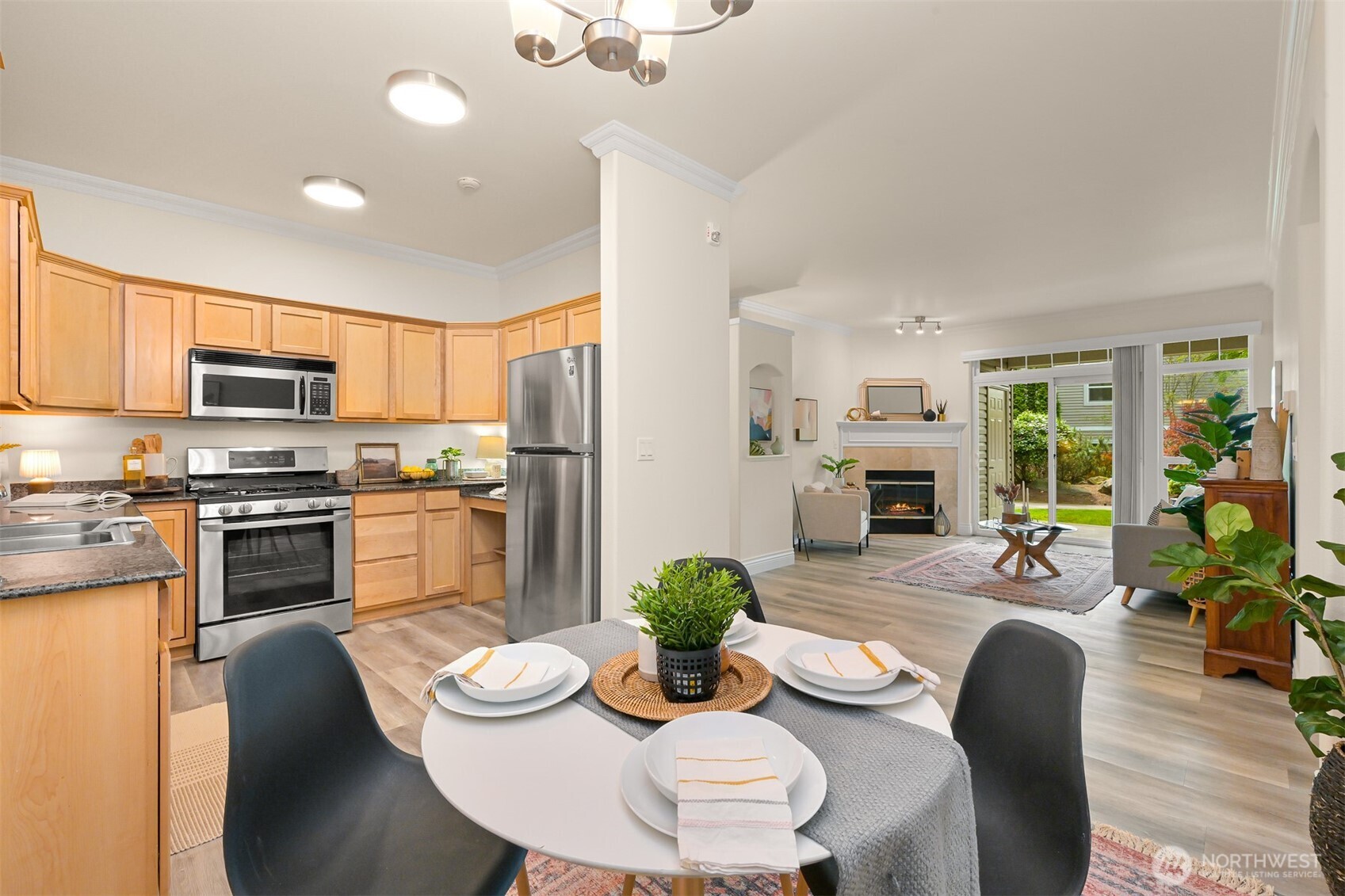 4579 El Dorado Way, Unit 107 Bellingham, WA 98226 - Photo 7 of 40 a kitchen with stainless steel appliances kitchen island granite countertop a dining table chairs and refrigerator