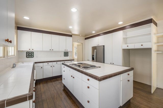 a spacious bedroom with two beds and a chandelier