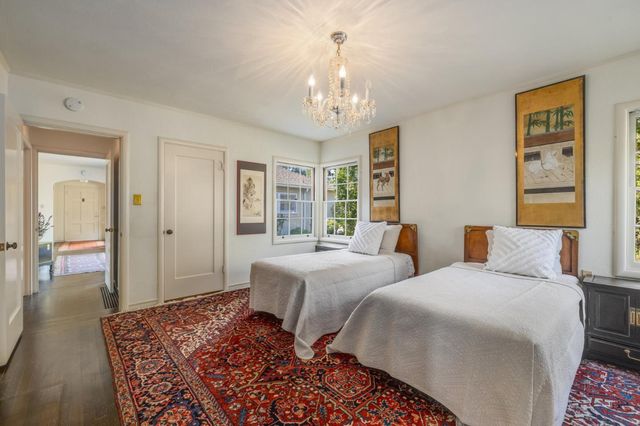 a kitchen with a refrigerator and white cabinets