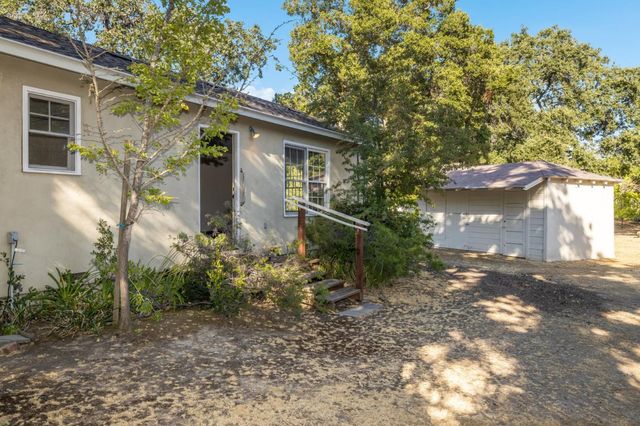 an aerial view of a house with a yard and garden