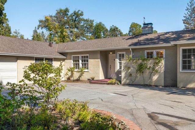 a living room with furniture a rug and a window