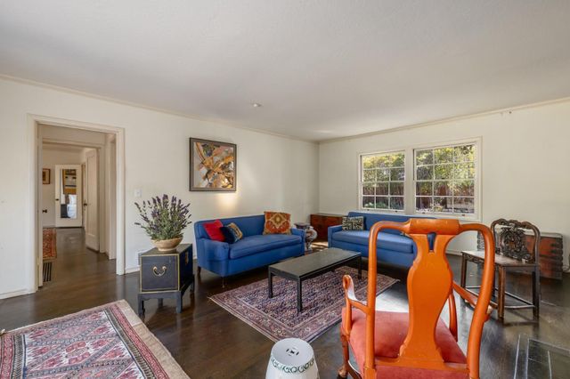 a living room with furniture fireplace and a table