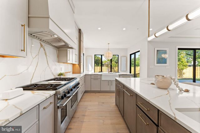 a kitchen with stainless steel appliances a sink dishwasher stove and oven