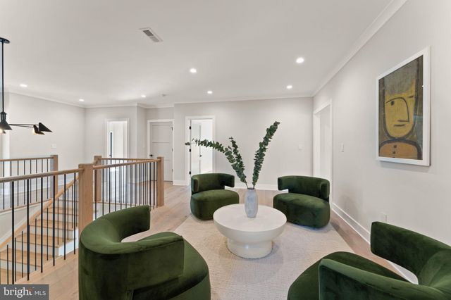 a spacious bedroom with a large bed and a chandelier