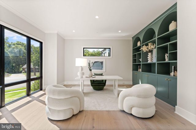 a view of a dining room and livingroom with furniture wooden floor a chandelier