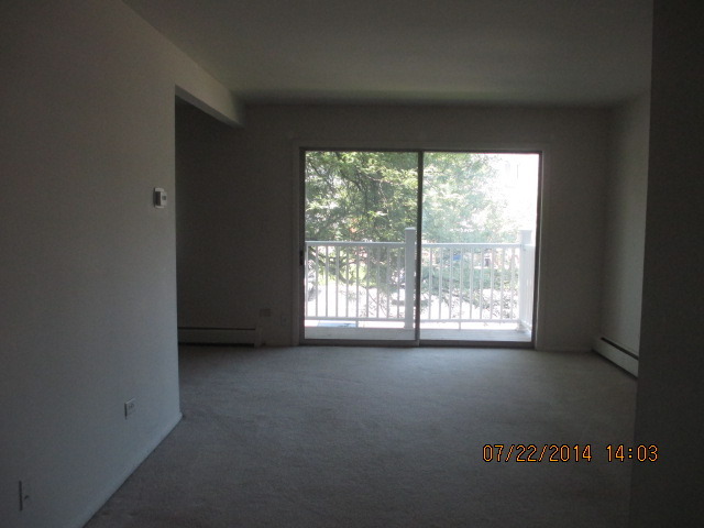 918 Ridge Square, Unit 202 Elk Grove Village, IL 60007 - Photo 4 of 6 a view of an empty room with a window