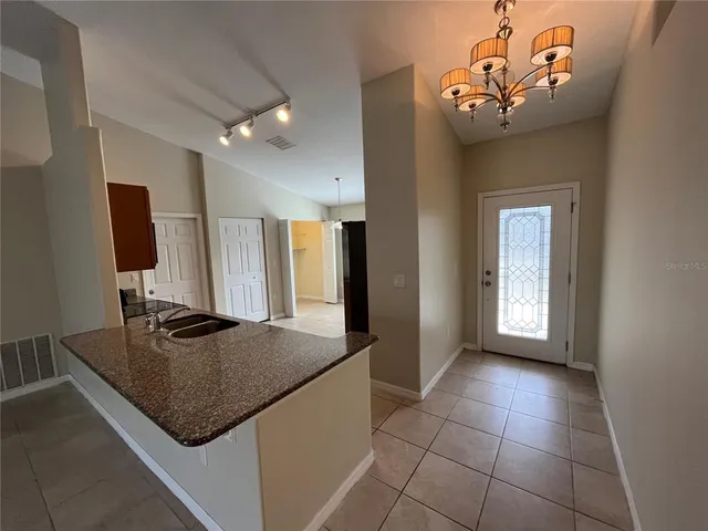 a kitchen with a sink a counter top space and a window
