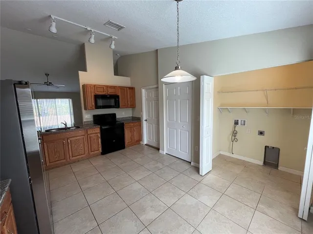a large kitchen with cabinets and stainless steel appliances