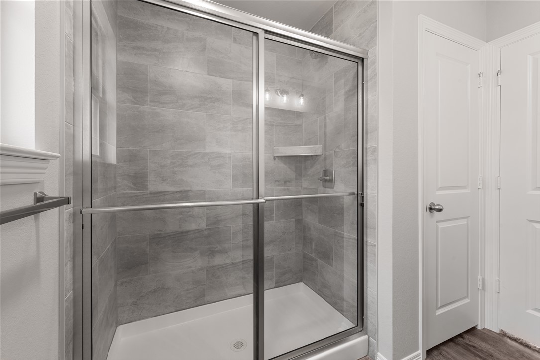 2869 Messenger Way Bryan, TX 77803 - Photo 17 of 23 a bathroom with a glass shower door