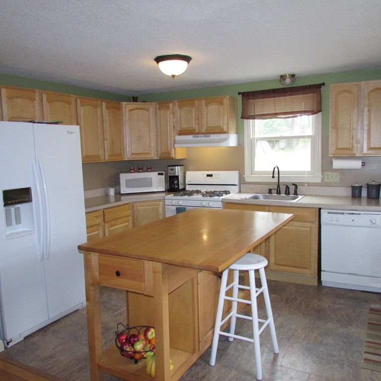 46 Edward Road Townsend, MA 01469 - Photo 3 of 23 a kitchen with a sink a stove a refrigerator and cabinets