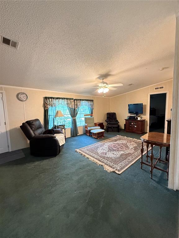 5109 Southwest 10th Street Bell, FL 32619 - Photo 3 of 38 a living room with furniture and a flat screen tv