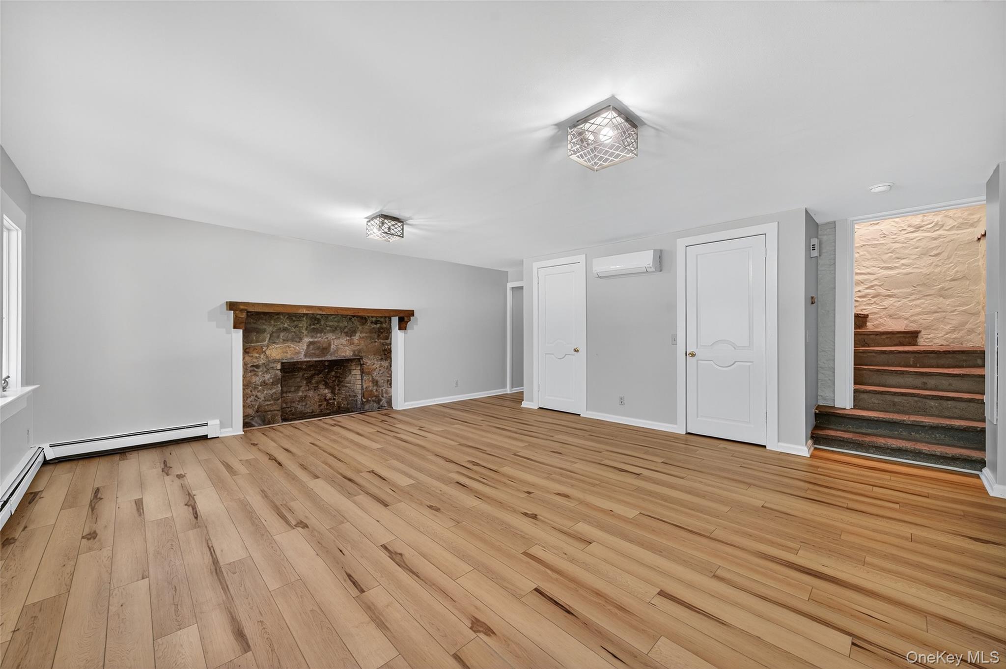 91 Sleepy Valley Road Warwick, NY 10990 - Photo 4 of 30 a view of empty room with wooden floor and fireplace