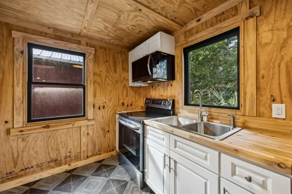 a kitchen with stainless steel appliances granite countertop a sink and a microwave